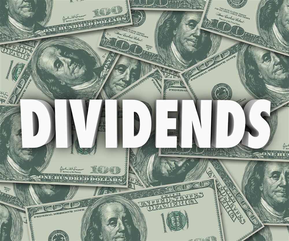 Dividends on background of dollar bills