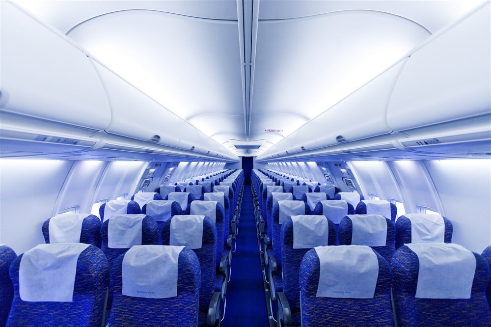 interior of passenger jet with blue seats, no passengers
