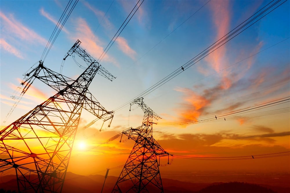 image of electric transmission lines at sunset