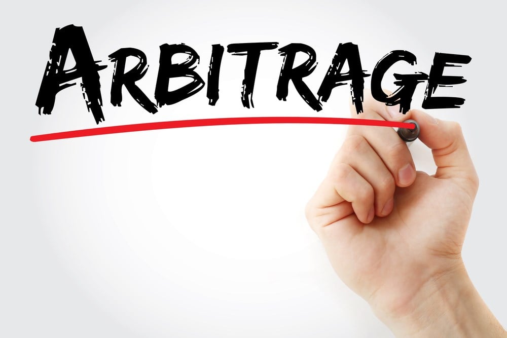 Hand writing Arbitrage with marker: What is arbitrage?