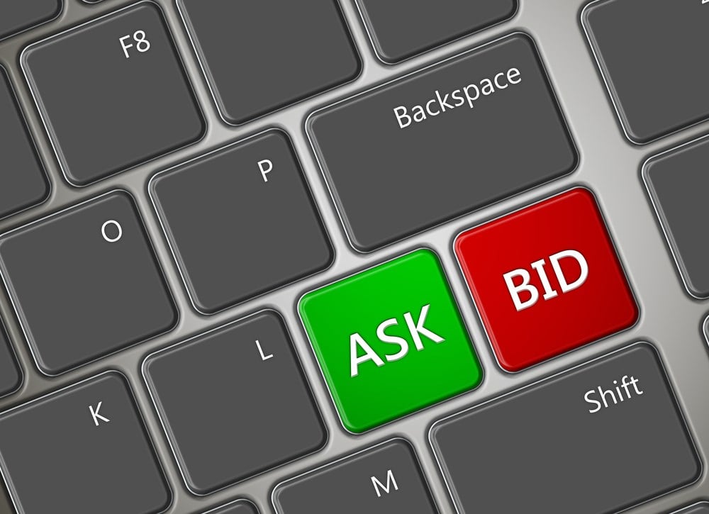closeup of computer keyboard with ask and bid buttons: What is bid-ask spread? Learn more.