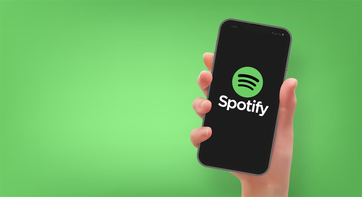 Woman hand holding the smartphone with logo Spotify, in vector format