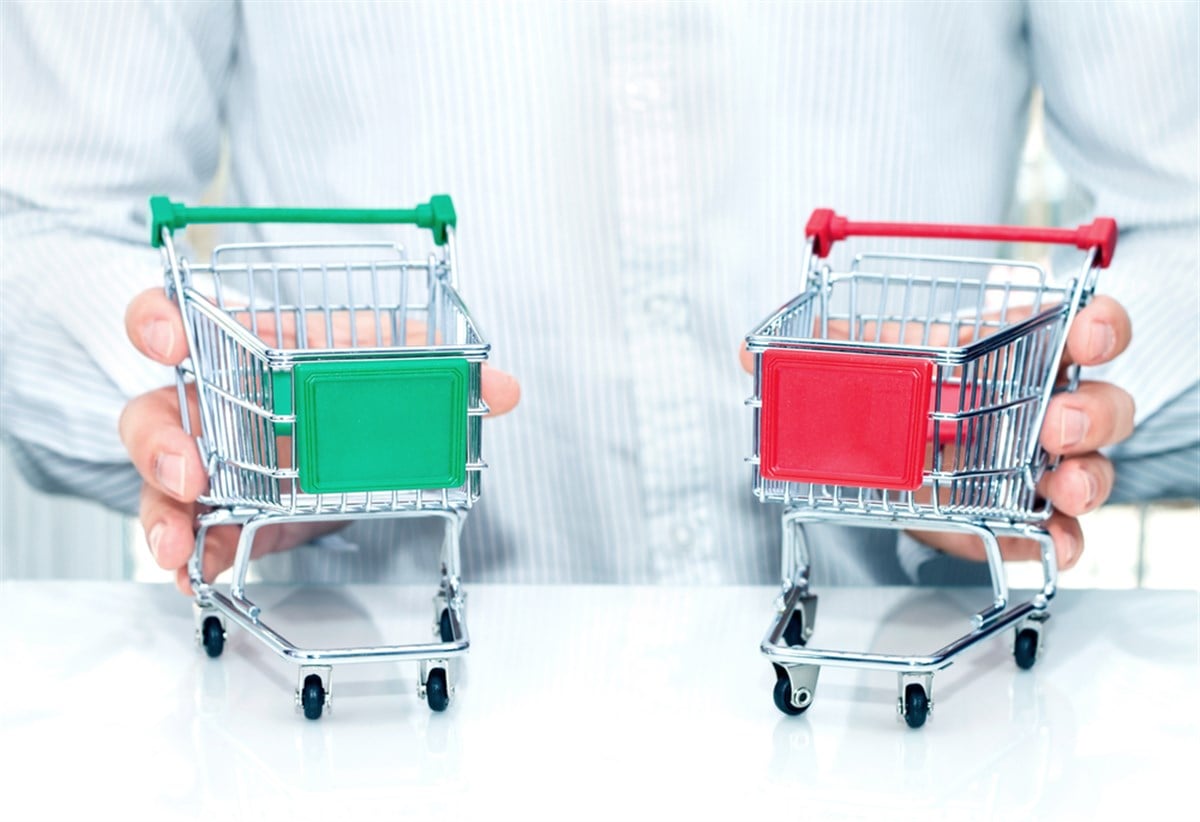 image of two shopping carts to illustrate consumer staples vs. consumer discretionary