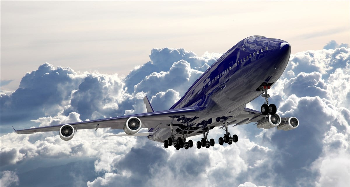 boeing jet breaking through the clouds after takeoff