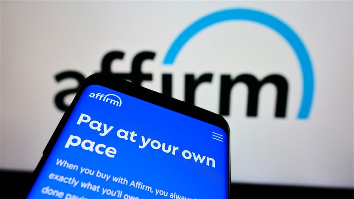 Image of affirm's logo and on a phone. Learn more about Affirm's stock in 2024.