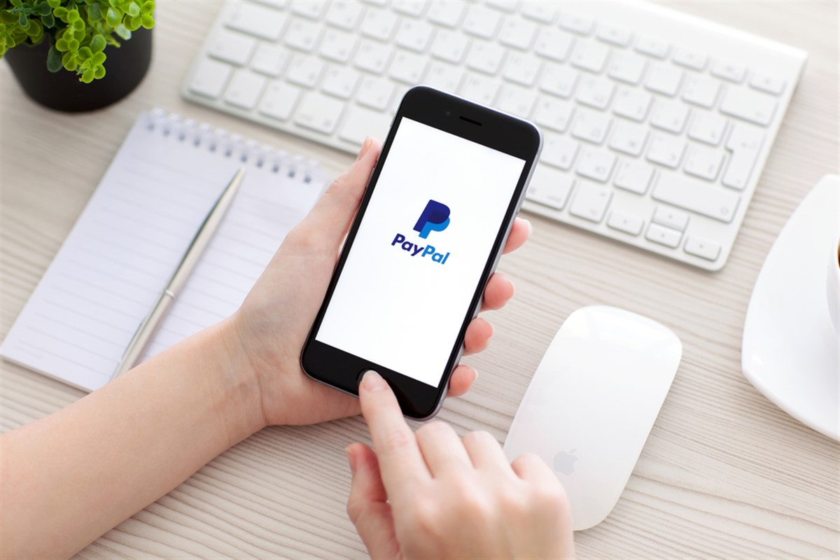 PayPal on iPhone screen at a desk