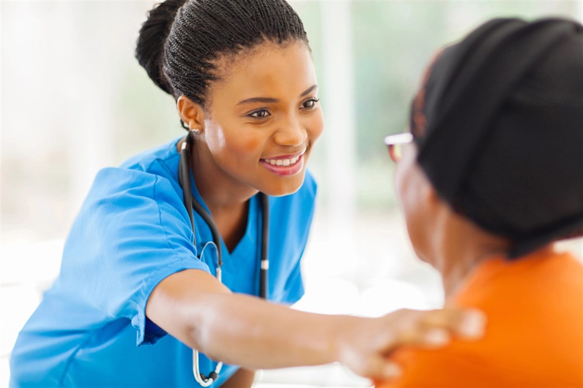 Image of nurse and patient; learn about healthcare stocks