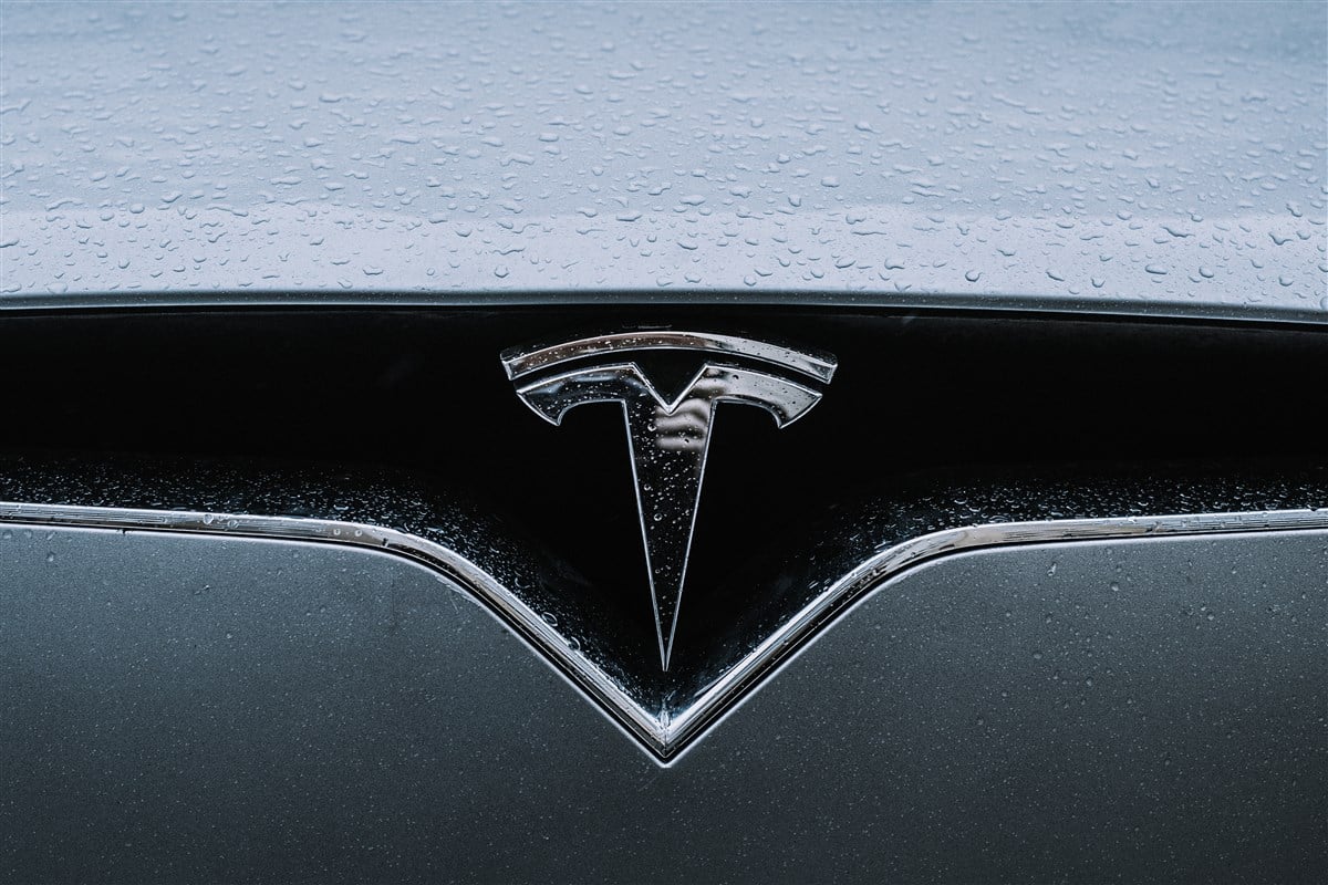 close-up image of tesla logo on vehicle