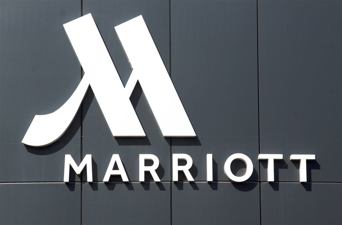 image of marriott logo on facade of hotel with grey background