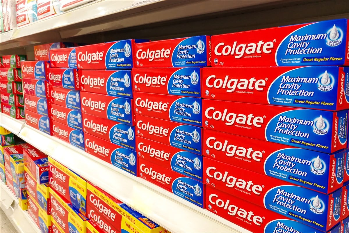 photo of rows of Colgate toothpaste on grocery store shelves