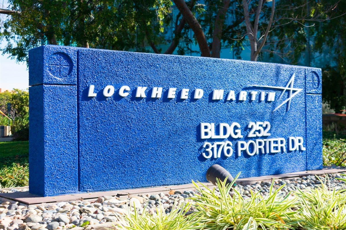 Lockheed Martin sign in front of building; learn more about defense stocks