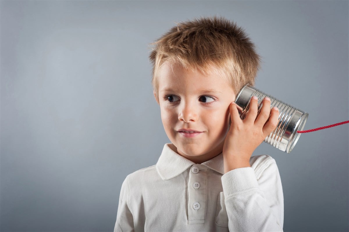 Image of a communication service with a tin can and a kid; learn more about communication services stocks.