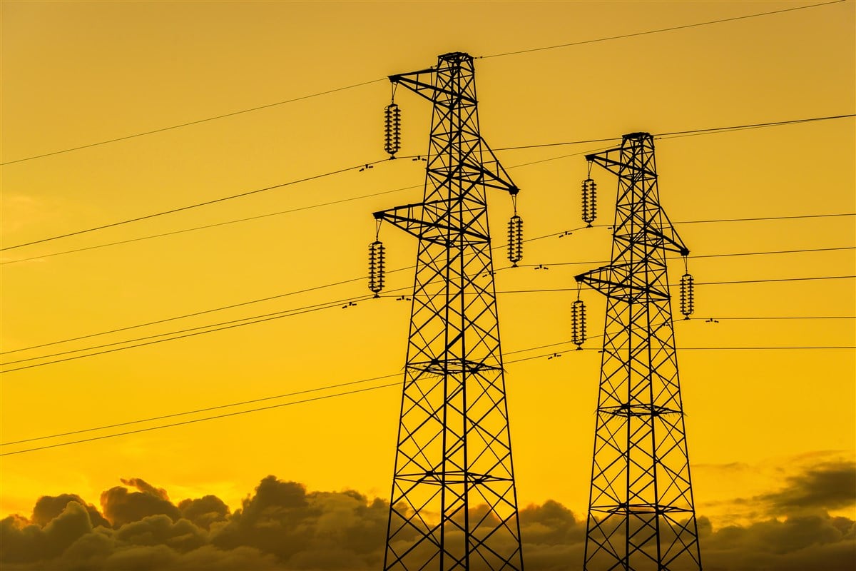 image of electric transmission lines at yellowing sunset