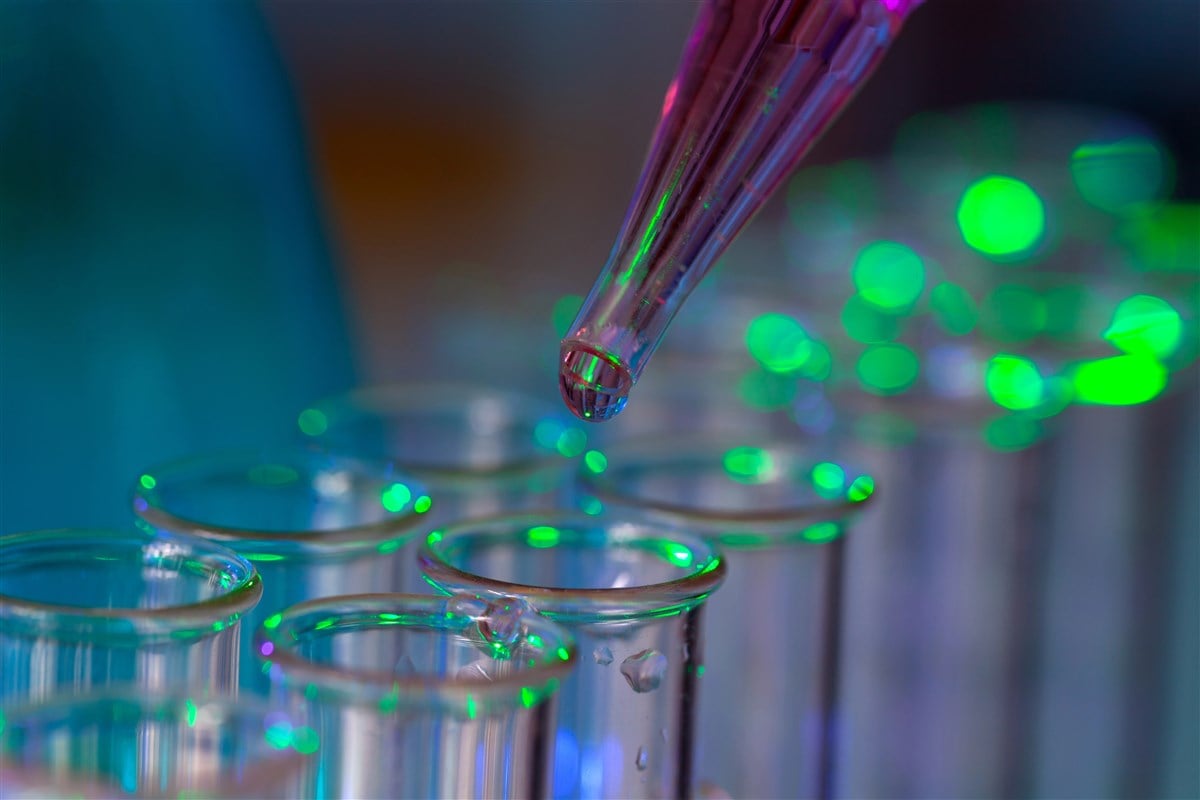 photo of pipette dropping chemical sample into test tube