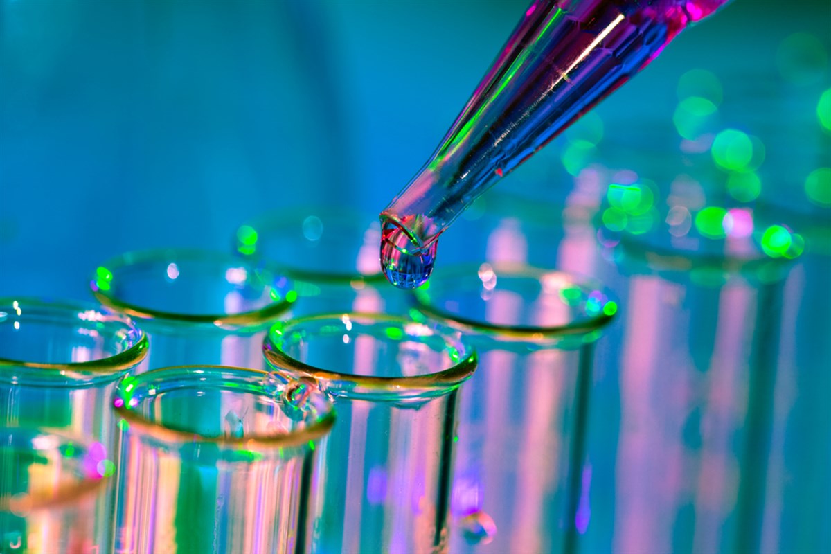 Pipette adding fluid to one of several test tubes