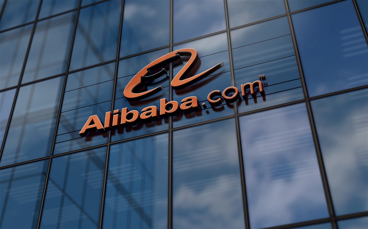 photo of orange alibaba logo on glass office building