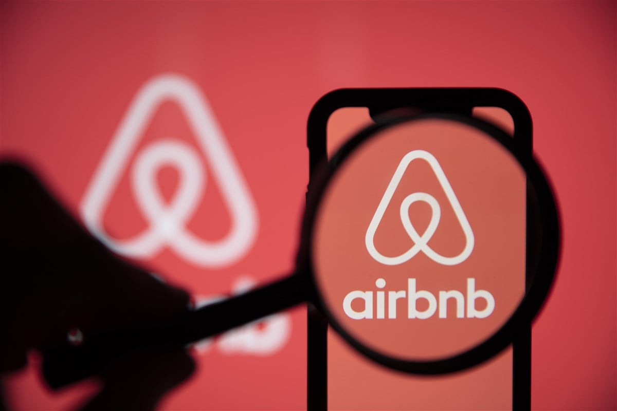 photo of Airbnb logo under a magnifying glass