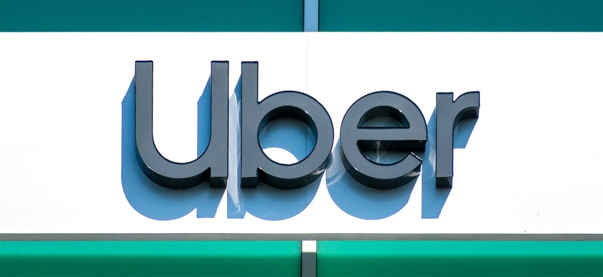 close-up photo of Uber sign and logo at global headquarters in California