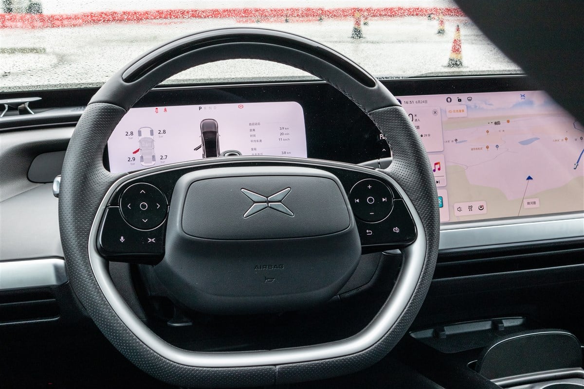 photo of interior of xpeng car showing logo on steering wheel