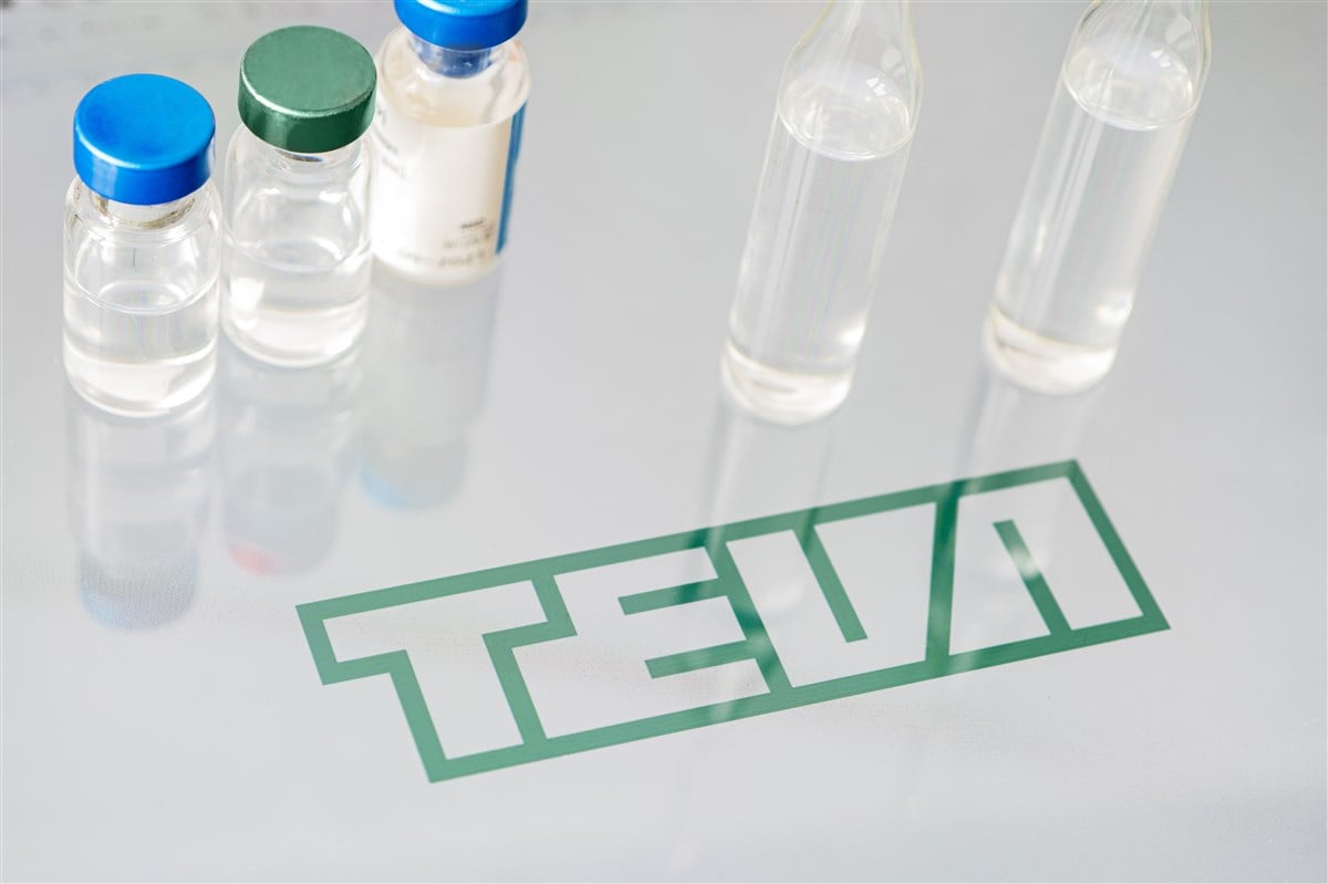 teva logo on glass table with vials of liquid