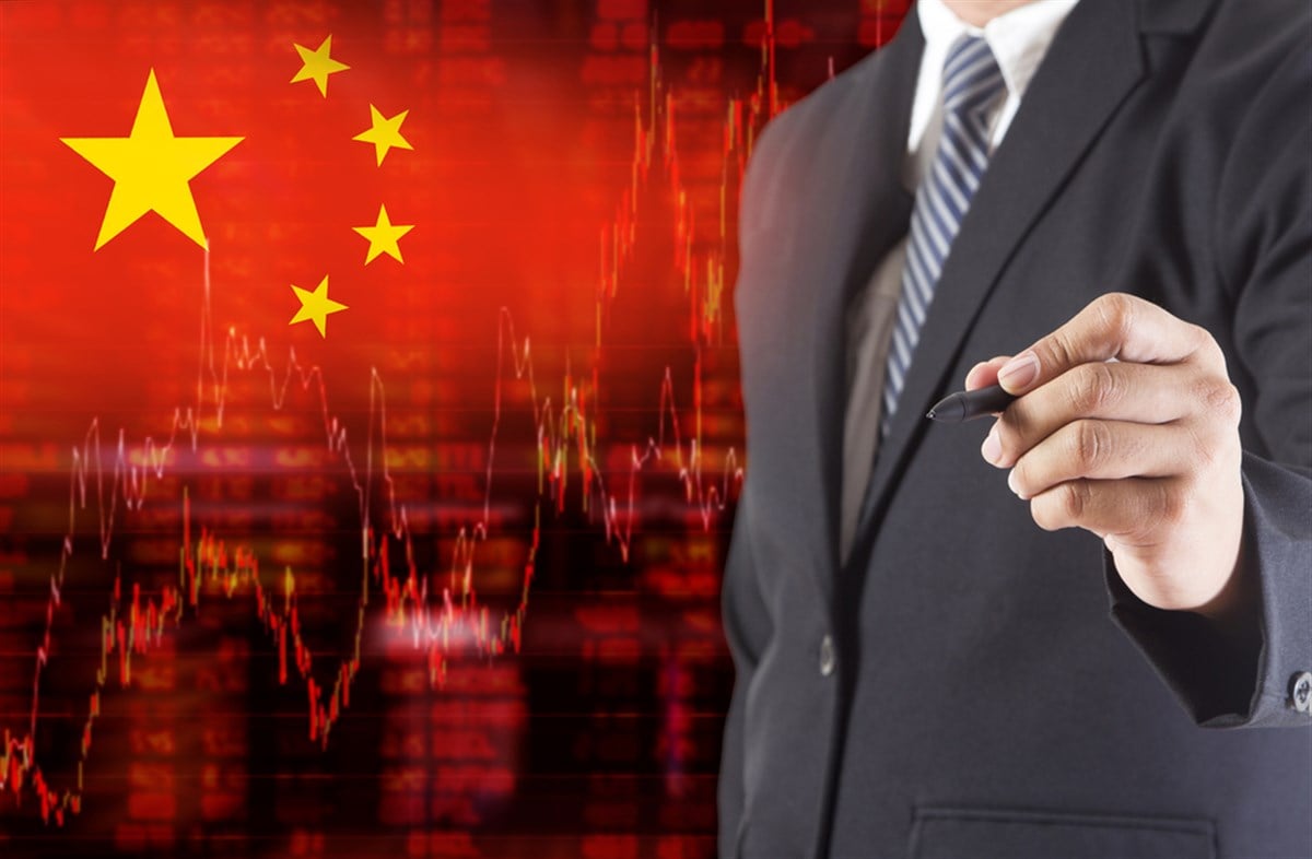 Flag of China. Downtrend stock data diagram with Businessman writing, drawing on the screen 