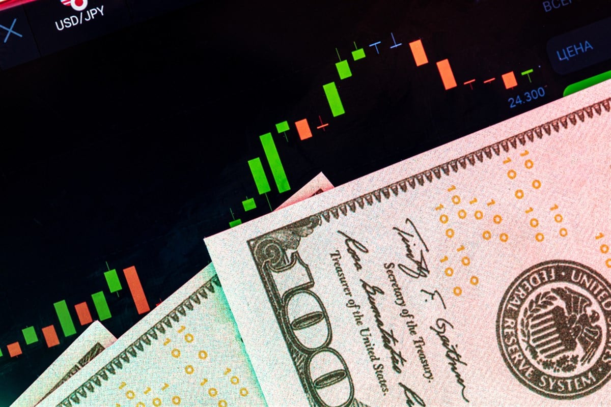 Dollars in front of a monitor with a price chart - upgraded stocks 