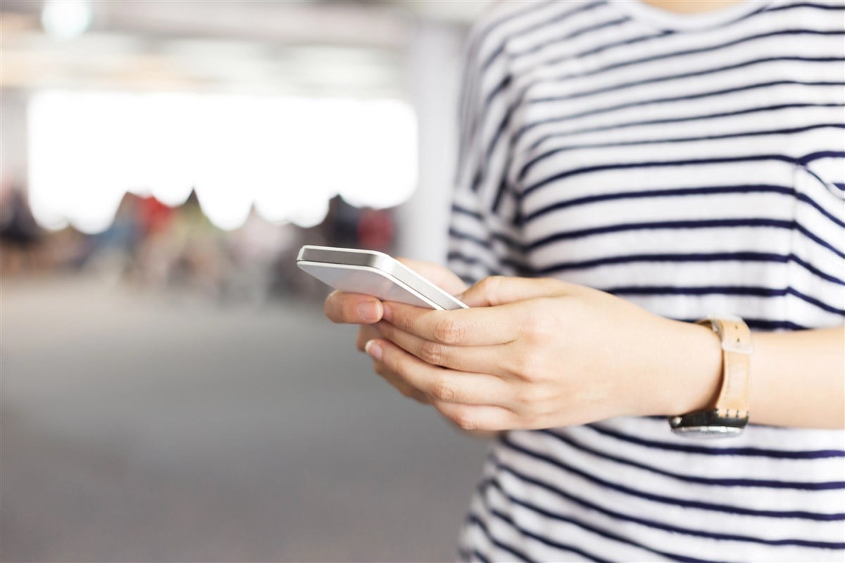 photo of woman holding mobile phone