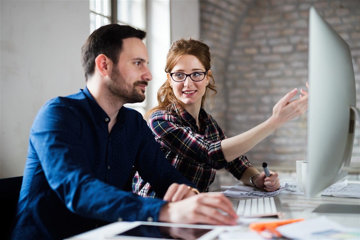 Image of male and female coworkers collaborating on a project