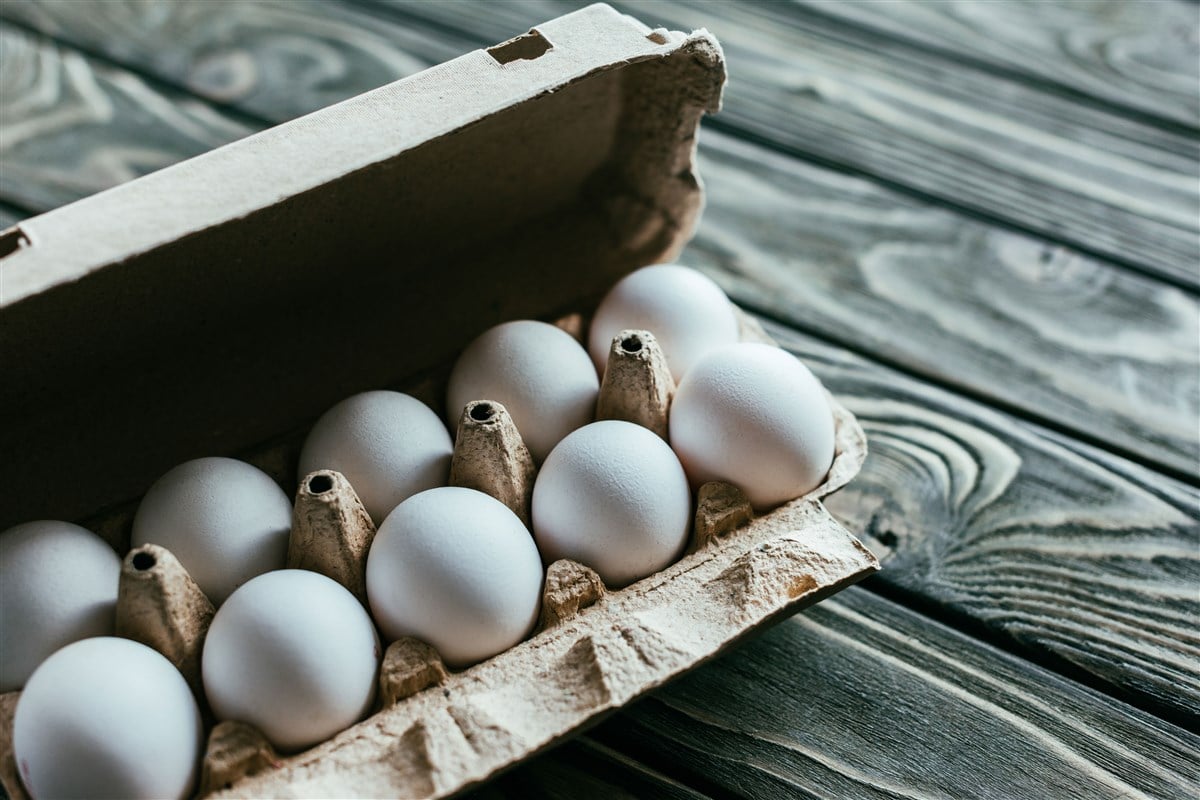 photo of open carton of white eggs