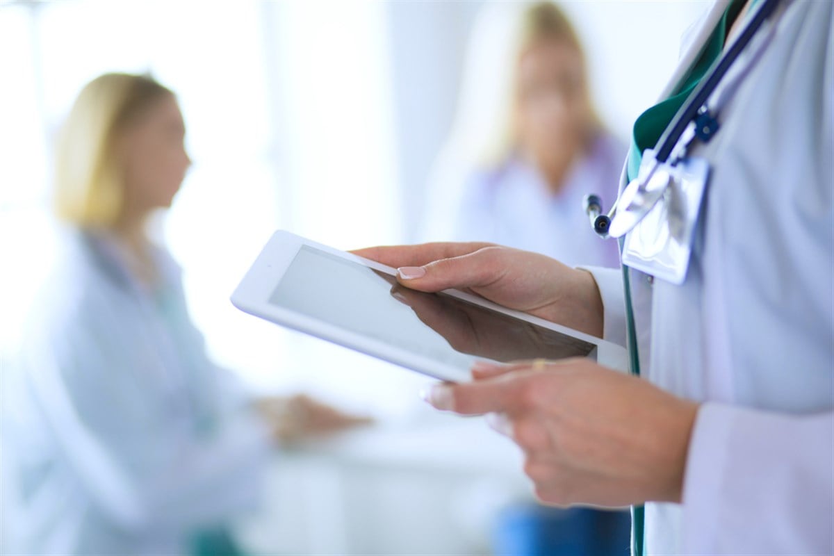 Photo of a doctor looking at an chart on a tablet. Undervalued UnitedHealth Group Stock Won’t Be For Long.