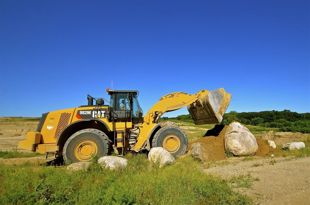 Photo of a Caterpillar machine at work in a field.  Caterpillar's market reset continues: expect further price drops.