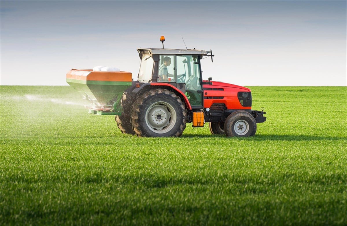 Photo of a tractor fertizling a field. First Quarter Earnings Indicate FMC Stock Has Bottomed Out.