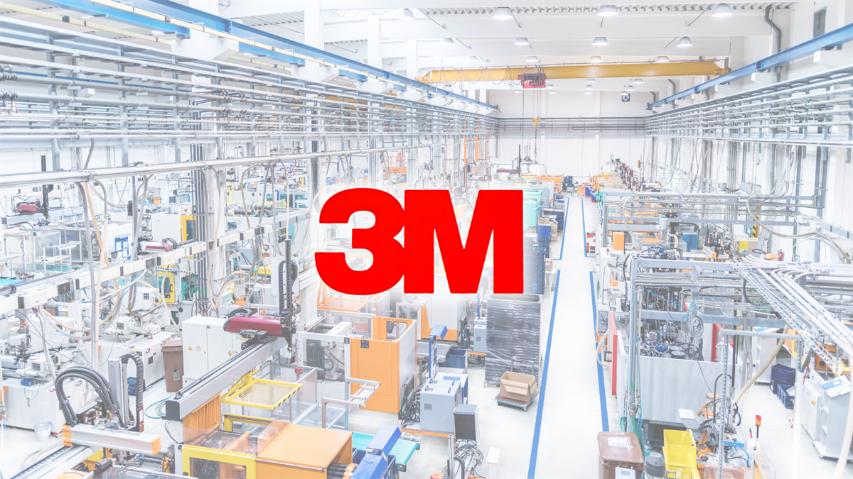 Bright industrial factory floor with large red 3M logo, signaling manufacturing strength and margin gains.