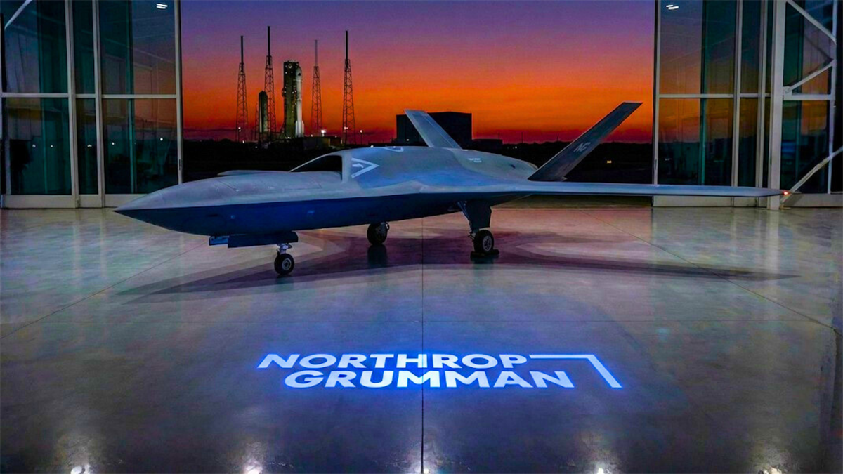 Northrop Grumman stealth drone in hangar at dusk, highlighting defense contractor NOC and military tech.