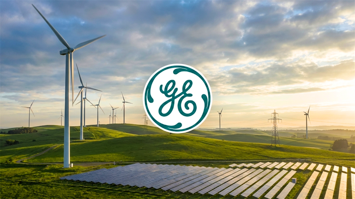 GE Vernova logo over wind turbines and a solar farm, underscoring renewable power buildout and the energy transition.
