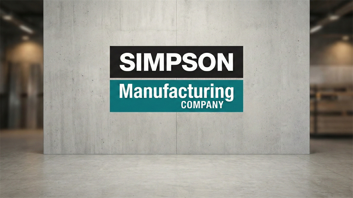 Simpson Manufacturing Company logo on a concrete wall inside a modern industrial hallway with soft blurred lights.