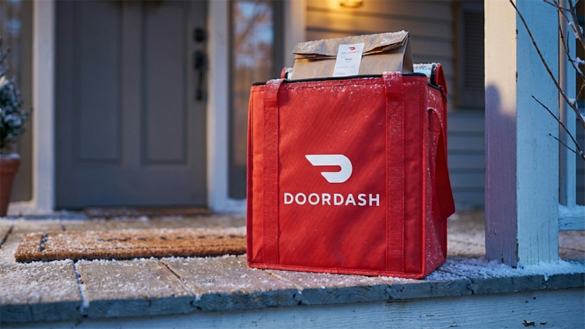 DoorDash delivery bag on a doorstep with food order visible, highlighting delivery demand and DASH stock focus.