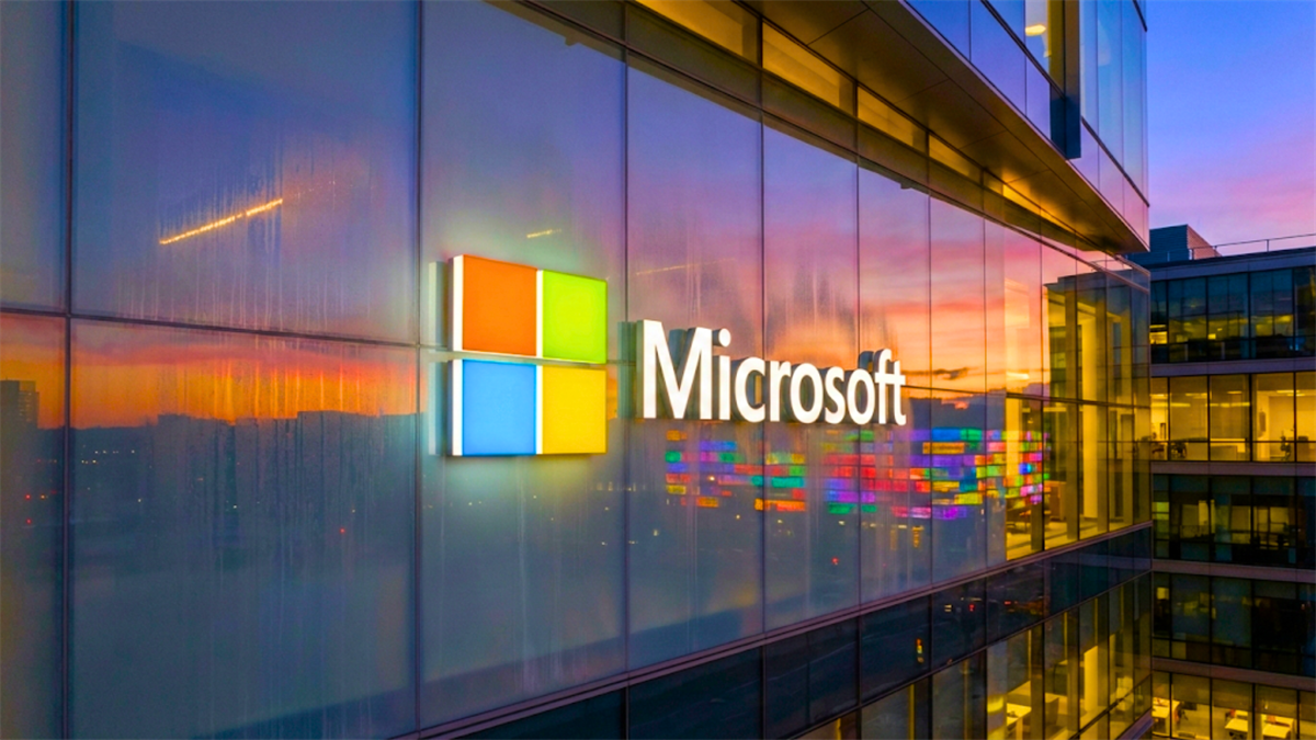 Microsoft logo on a glass office building at dusk, reflecting tech sector sentiment and MSFT stock focus.