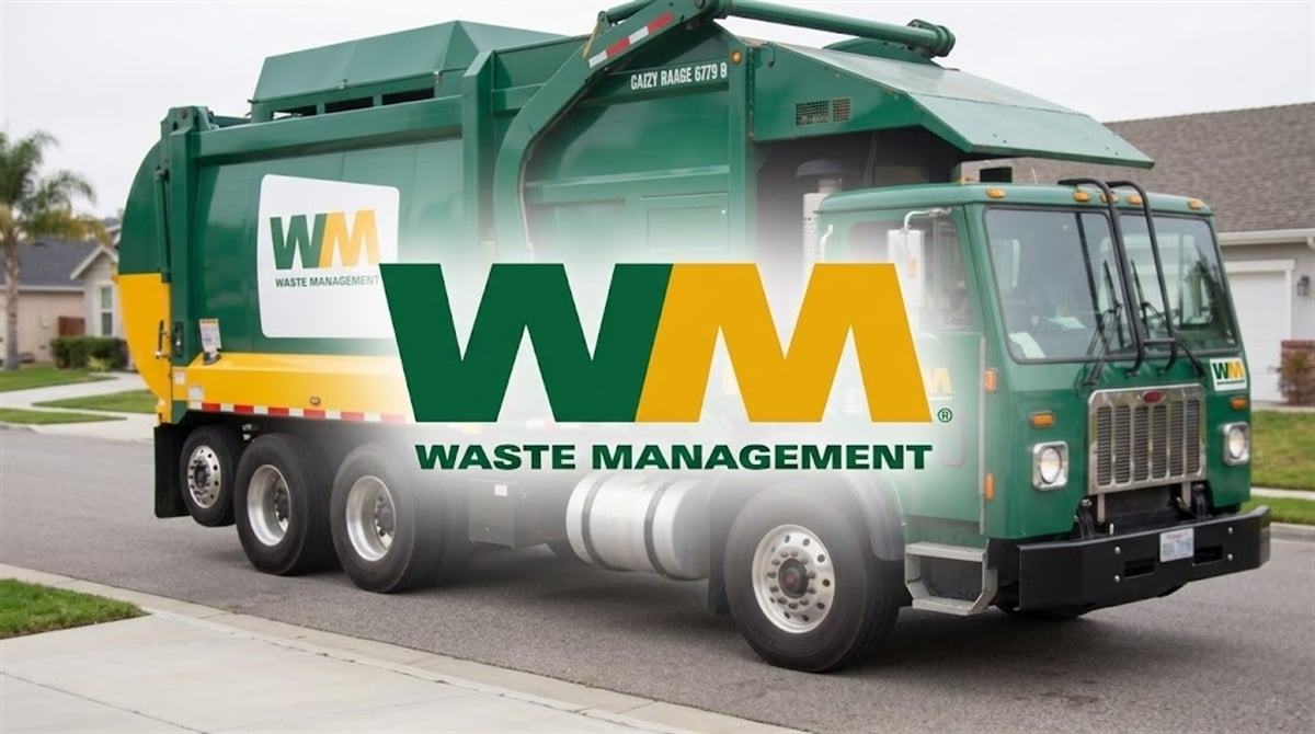 A Waste Management branded green and yellow garbage truck parked in a residential neighborhood.