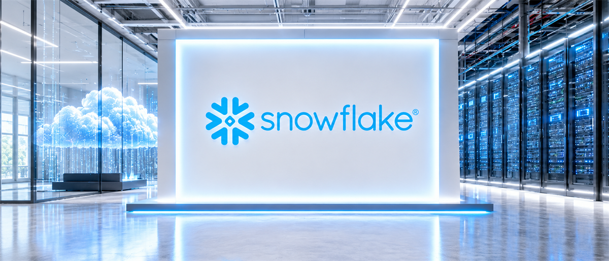 Snowflake logo displayed on illuminated wall in a data center setting with server racks visible.