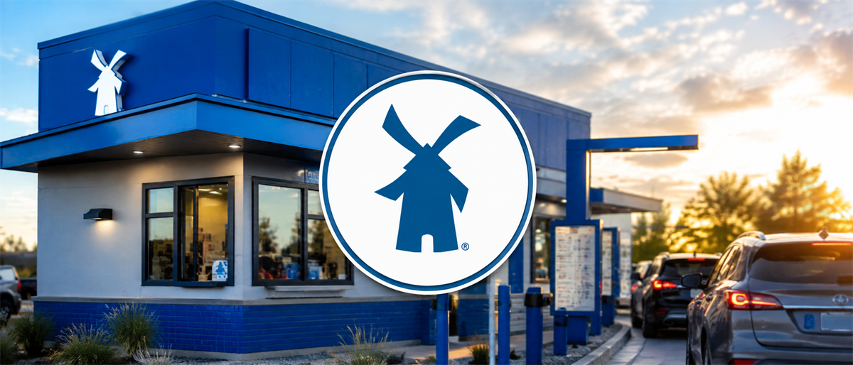 Dutch Bros drive-thru location with windmill logo signage and cars in line at dusk.