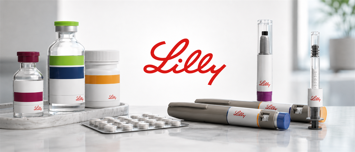 Eli Lilly logo displayed among medicine vials, pill bottles, blister packs, and injector pens on a table.