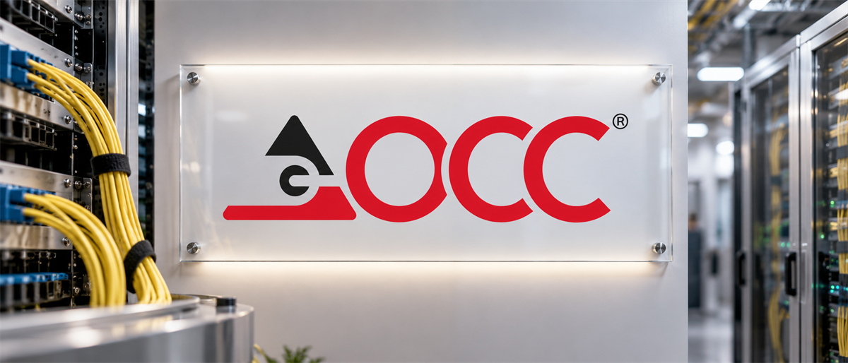 OCC logo displayed on a lit wall sign inside a data center with server racks and yellow cabling.