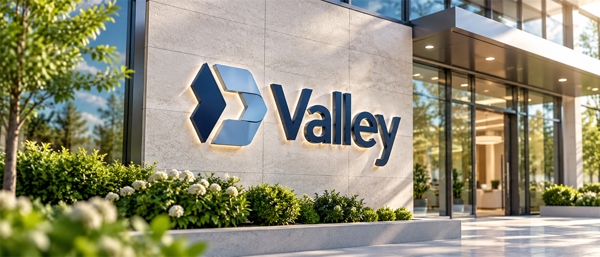 Valley National Bancorp logo and sign displayed on an exterior building wall near a glass entrance.