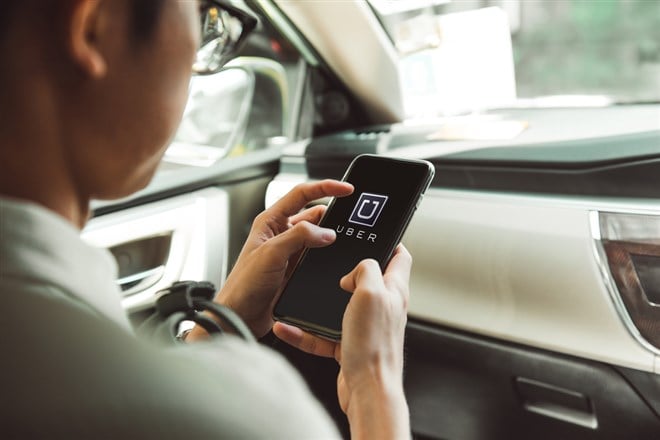 BANGKOK, THAILAND - JANUARY 22: A man using Uber app on smartphone on January 22, 2017 in Bangkok.