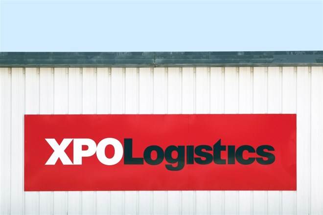 XPO Logistics logo on a building; learn more about XPO stock
