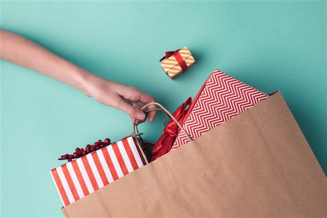 decorated presents inside brown paper shopping bag