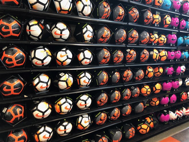 photo of rows of soccer balls at unnamed sporting goods store