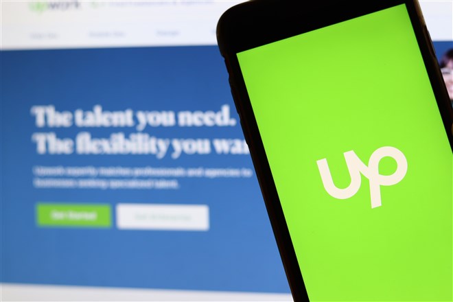 upwork logo on mobile device with upwork home screen in background