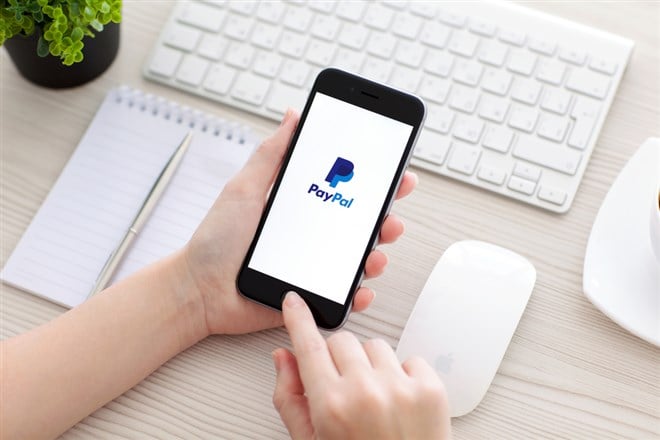PayPal on iPhone screen at a desk